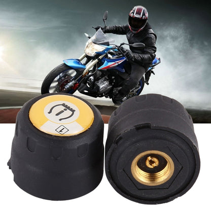 Set of two black TPMS sensor caps with yellow indicator face and visible brass insert