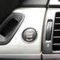 Gray start-stop engine button cover with chrome rim and engraved text