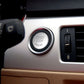 Black start-stop engine button cover with chrome rim in center console
