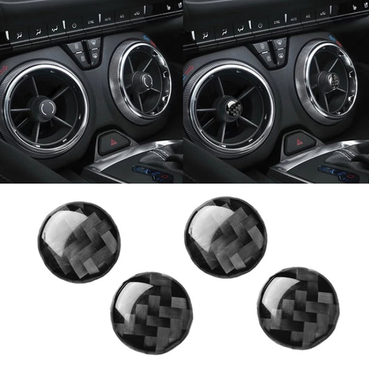 Set of four round carbon-fiber look air vent decorative stickers installed in car console