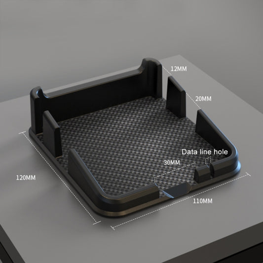 Black dashboard organizer tray with textured surface, side phone stands, and data hole