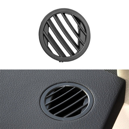 Circular dashboard air outlet vent with black slats and textured trim mount