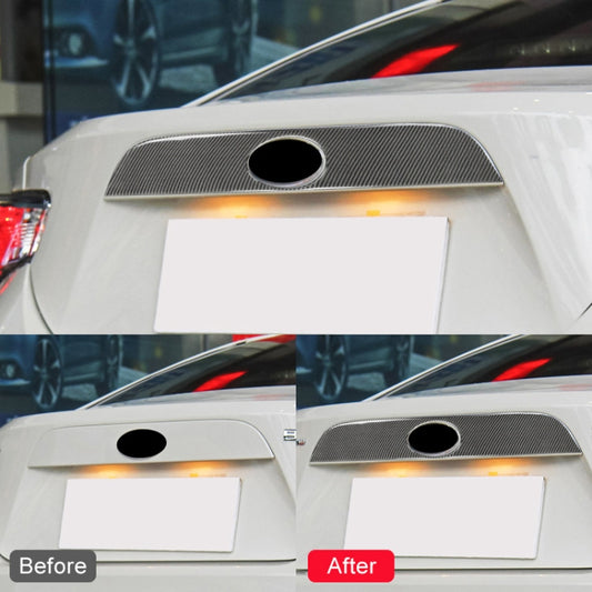 Black carbon fiber rear logo strip mounted on car, round cutout