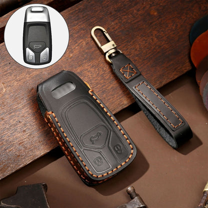 Car key protective case set in black leather with orange stitching, includes key fob cover and strap