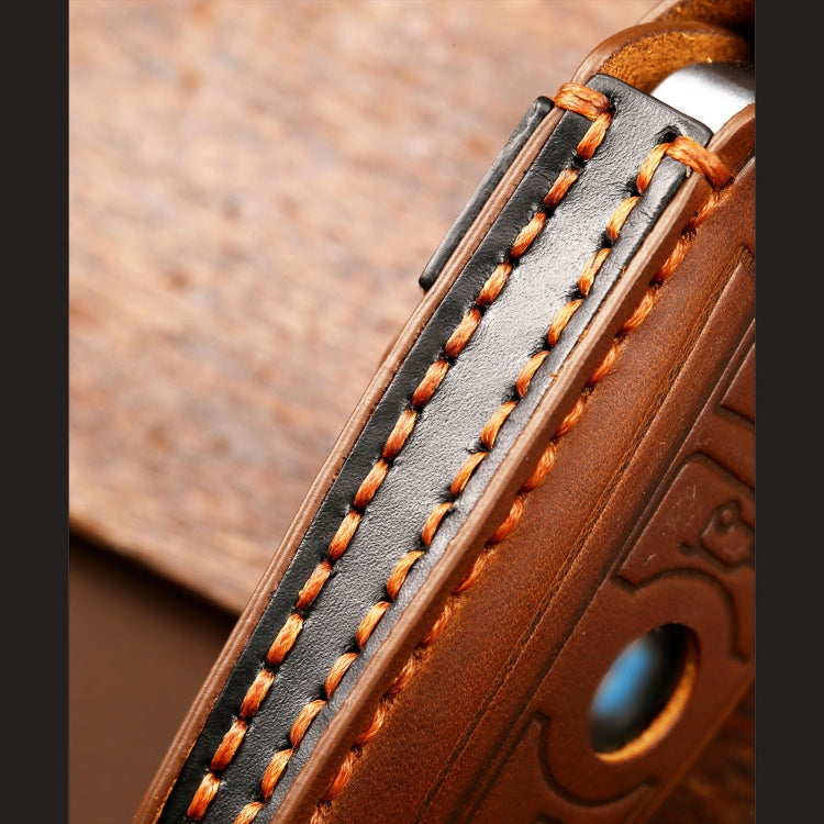 Close-up of stitched edge on blue leather key fob cover with emblem front
