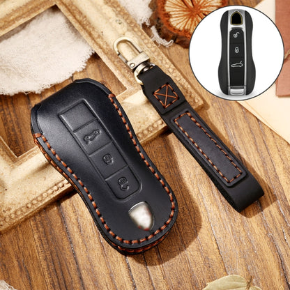 Black leather key fob cover with orange stitching and embossed key buttons, car key case