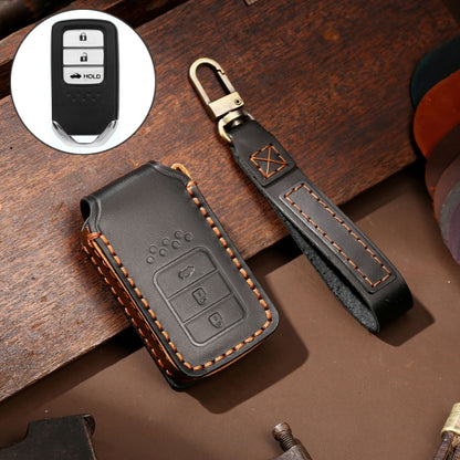 Black leather key fob cover with orange stitching and key ring holder