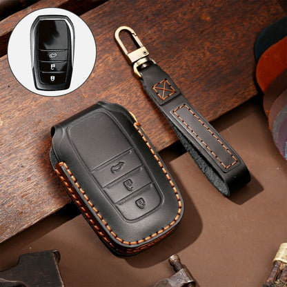 Leather key fob protective cover in black with stitched edge and button cutouts