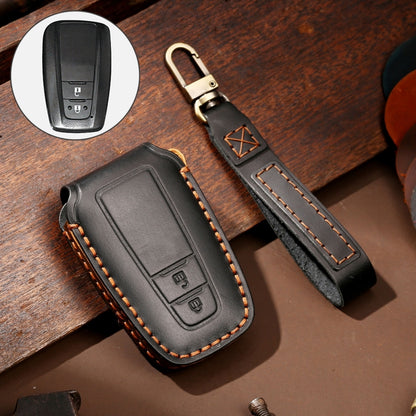 Black leather key fob protective cover with brown stitching and metal key ring loop