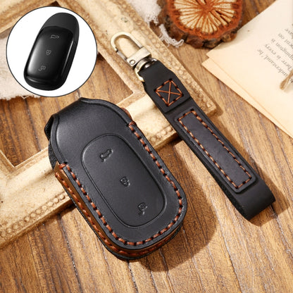 Black leather key fob protective cover with orange-brown edge stitching and key ring