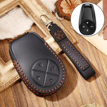 Black leather key fob protective cover with stitching and circular button design.