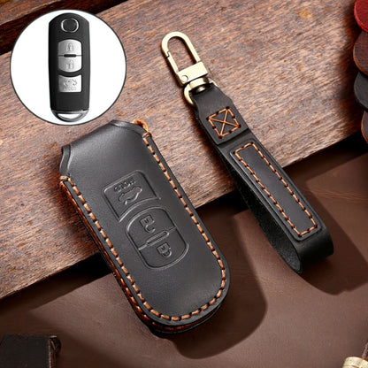 Black 3-button leather key fob cover with metal ring, stitched edges, and embossed logo panel.