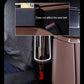 Black car side storage console with cup holders beside the seat belt area