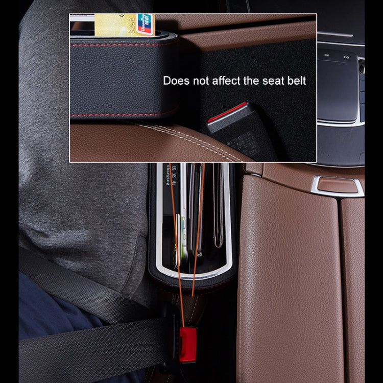Black car side storage console with cup holders beside the seat belt area