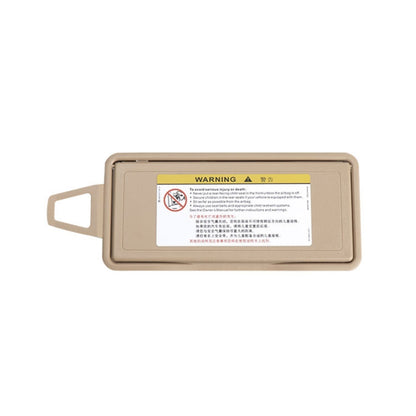 Beige right car sun visor makeup mirror with warning label, closed cover