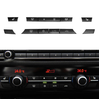 Car A/C control switch panel with 11 black buttons and two temperature displays