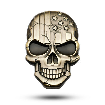Metal devil skull car sticker in bronze and black with raised star-and-grin detail