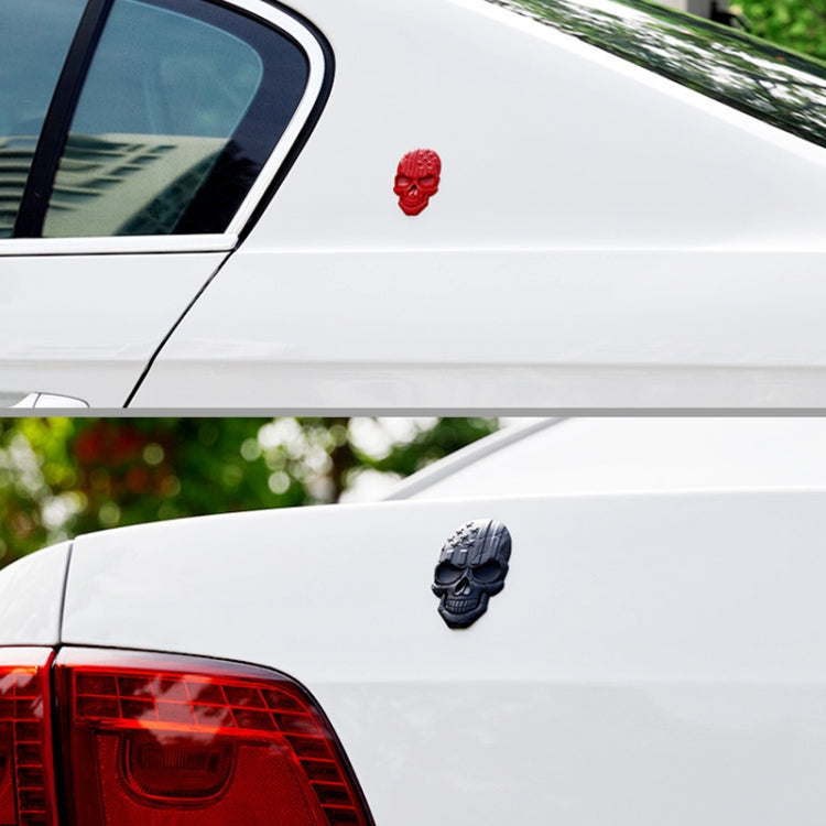 Red and black devil skull metal car stickers placed on a vehicle body
