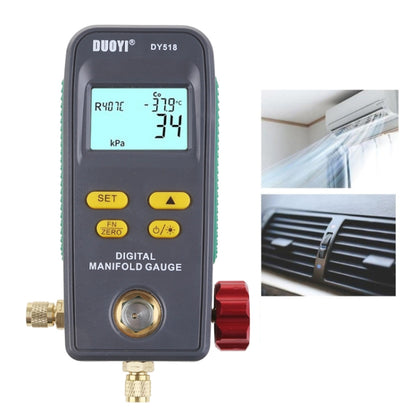 Digital manifold gauge with LCD screen, yellow controls, and brass pressure fittings