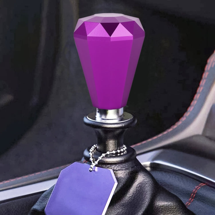 Diamond-faceted gear shift knob in purple with metal base and ring