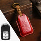 Red leather key fob protective cover with stitched edges and metal keyring loop
