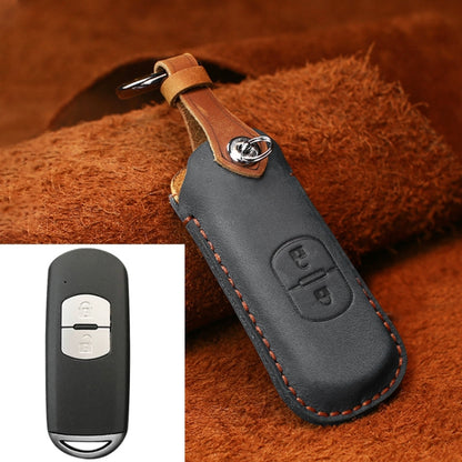 Black leather key protective cover with metal keyring, stitched edges, embossed button panel