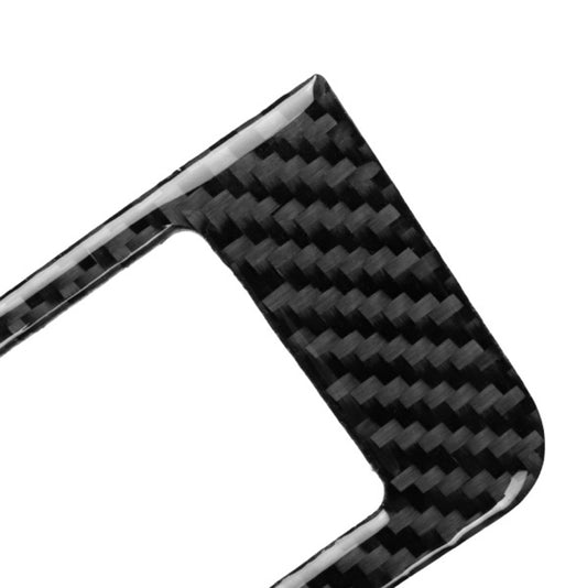Carbon fiber window lift switch panel overlay, close-up corner with glossy weave