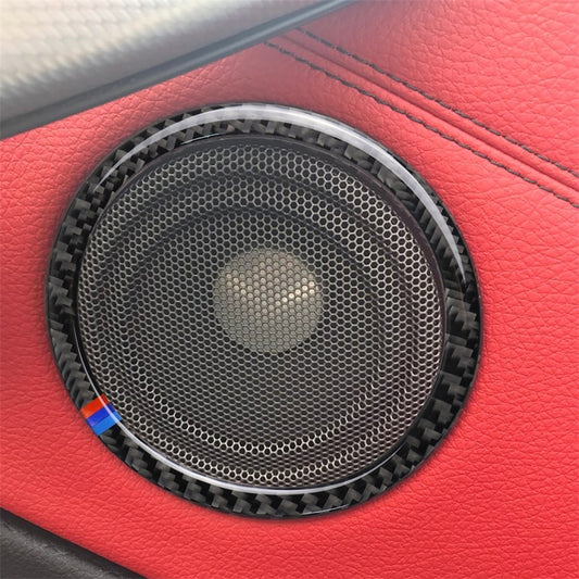 Carbon fiber horn ring sticker with mesh speaker grille, installed on red car interior