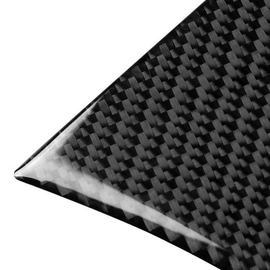 Close-up carbon fiber rear window trim corner, glossy woven texture in dark black