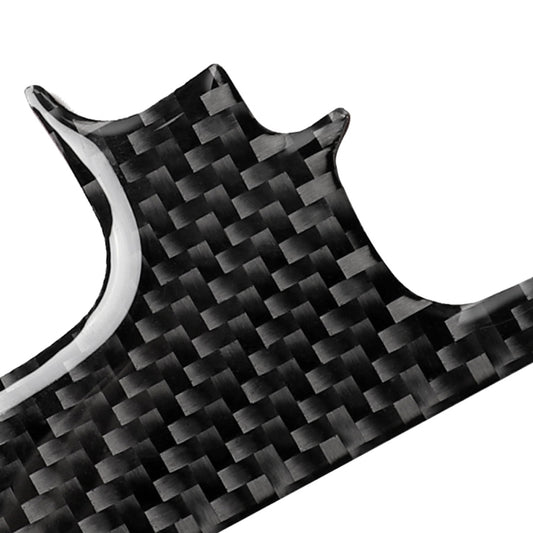 Close-up dark carbon fiber gear sticker with curved cutout edges