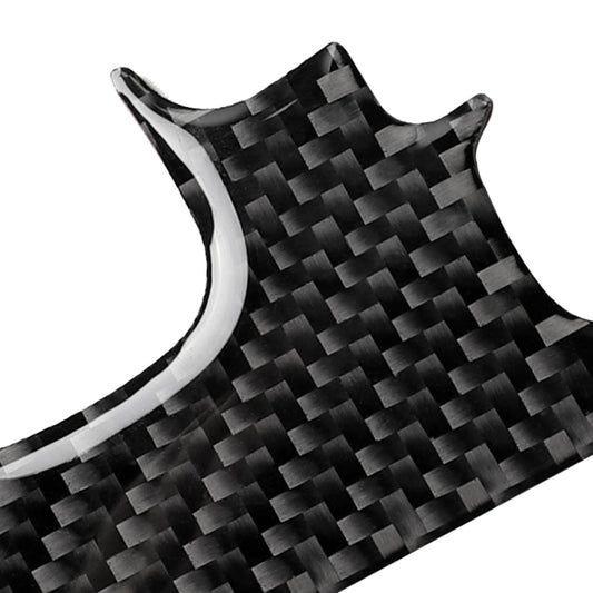 Close-up of black carbon fiber gear B sticker with glossy weave texture