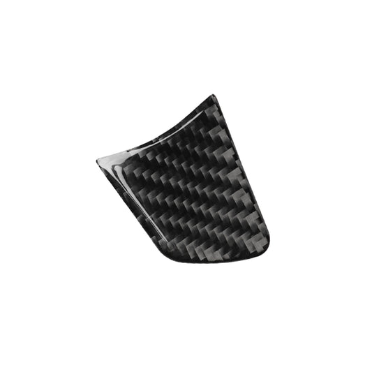 Single curved black carbon-fiber steering wheel button cover with woven texture