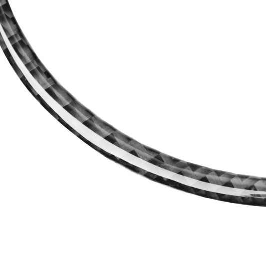 Curved edge of black carbon-fiber steering wheel logo sticker ring with checkered pattern