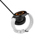 Smart watch with black magnetic charging dock attached, orange status ring
