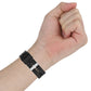 Black silicone watch strap close-up on wrist with metal buckle and pin holes