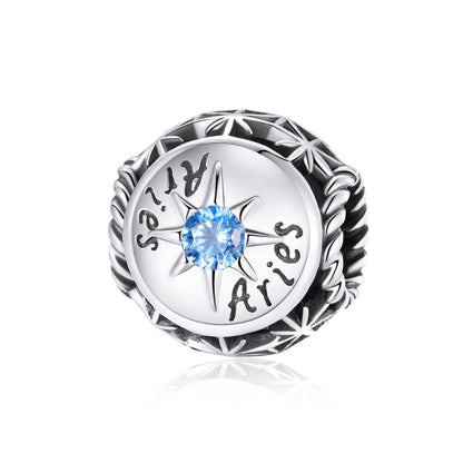Sterling silver zodiac ring with light blue zircon center and engraved constellation symbols
