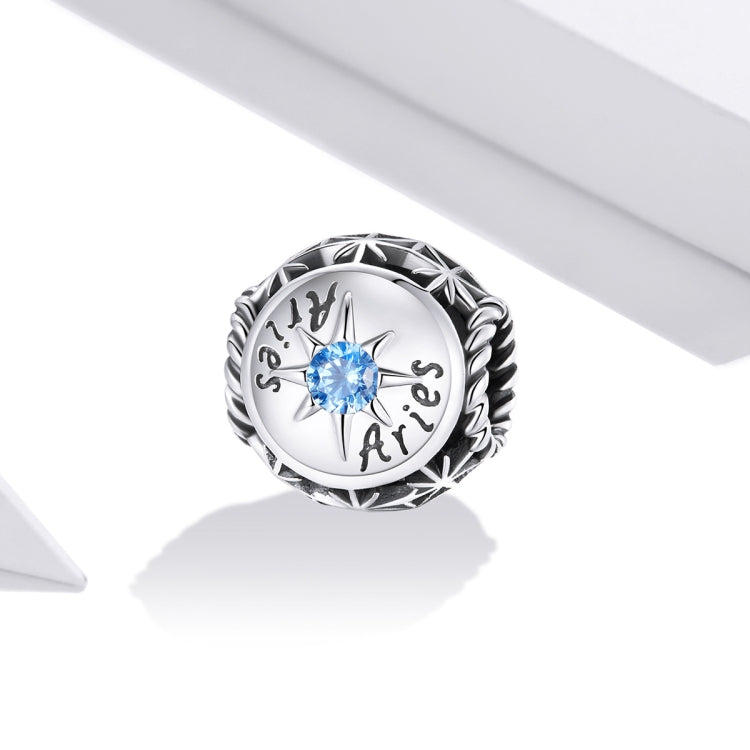 Sterling silver zodiac ring with light blue zircon center, engraved zodiac script, close view