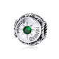Sterling silver zodiac ring with green zircon center, starburst bezel, engraved constellation marks