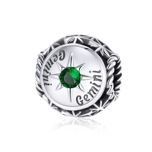 Sterling silver zodiac ring with green zircon center, starburst bezel, engraved constellation marks