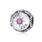 Sterling silver zodiac ring with pink zircon center, starburst bezel, engraved constellation symbols