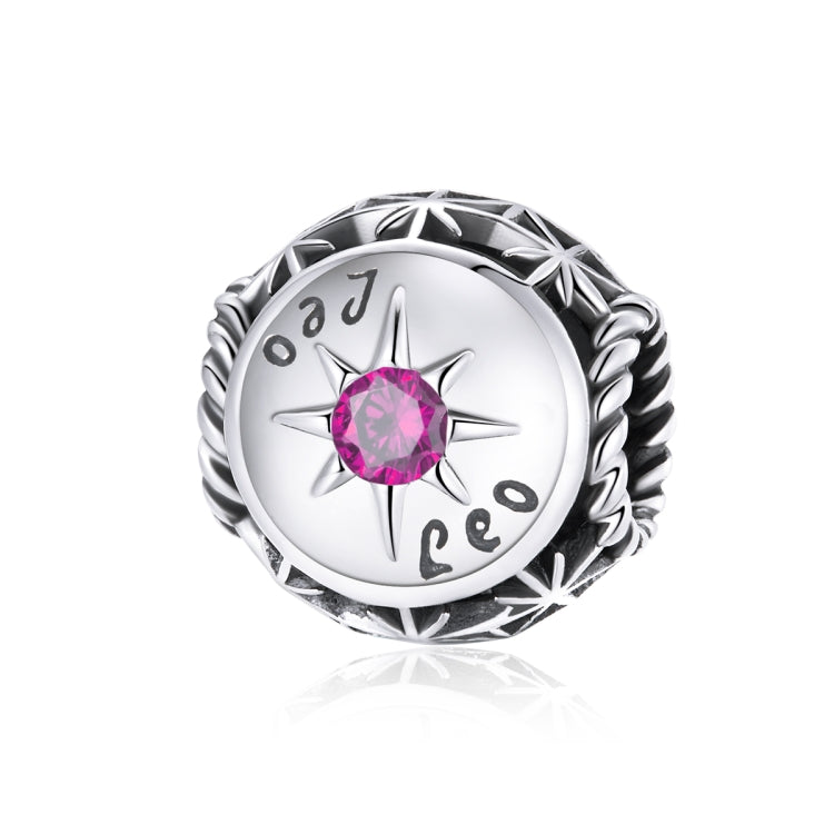 Sterling silver zodiac ring with pink zircon center, starburst bezel, engraved constellation symbols