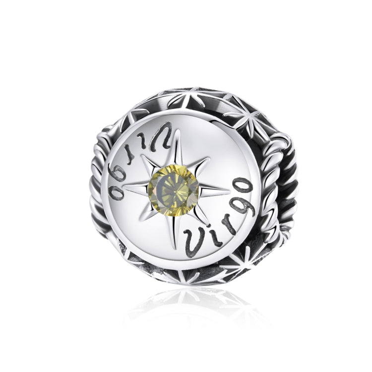 Sterling silver zodiac ring with yellow-green zircon center, starburst bezel, engraved zodiac marks