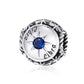 Sterling silver zodiac ring with dark blue zircon center, starburst bezel, engraved constellation symbols