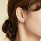 Sterling silver open line earrings on ear, angular U-shaped hoops