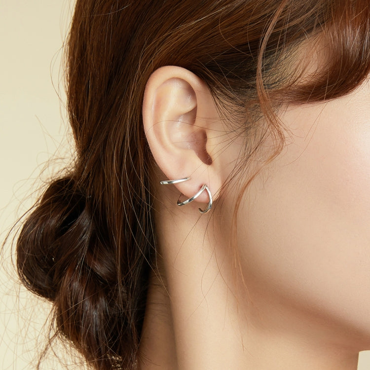 Sterling silver open line earrings on ear, angular U-shaped hoops