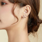 Sterling silver open line earrings on ear, curved angular U hoop style