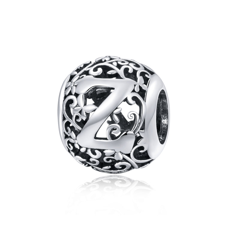 Sterling silver hollow letter bead charm with ornate cutout lettering in a round bezel