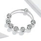 Silver-tone beaded bracelet with round carved letter charms and mesh-like stretch cord