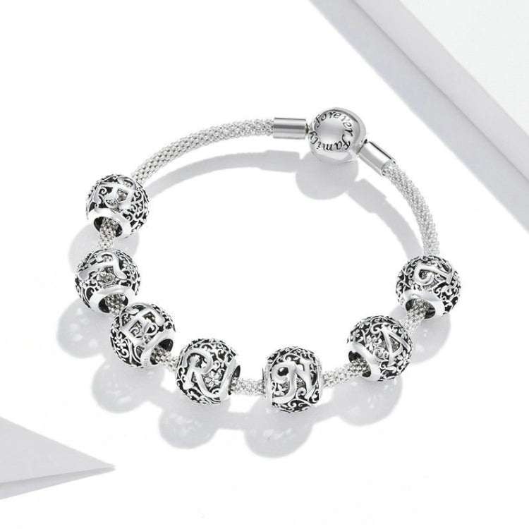 Silver-tone beaded bracelet with round carved letter charms and mesh-like stretch cord