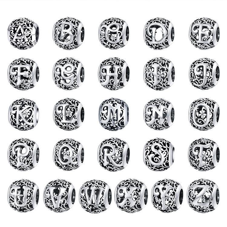 Set of sterling silver hollow letter charm beads with ornate filigree, multiple letters shown